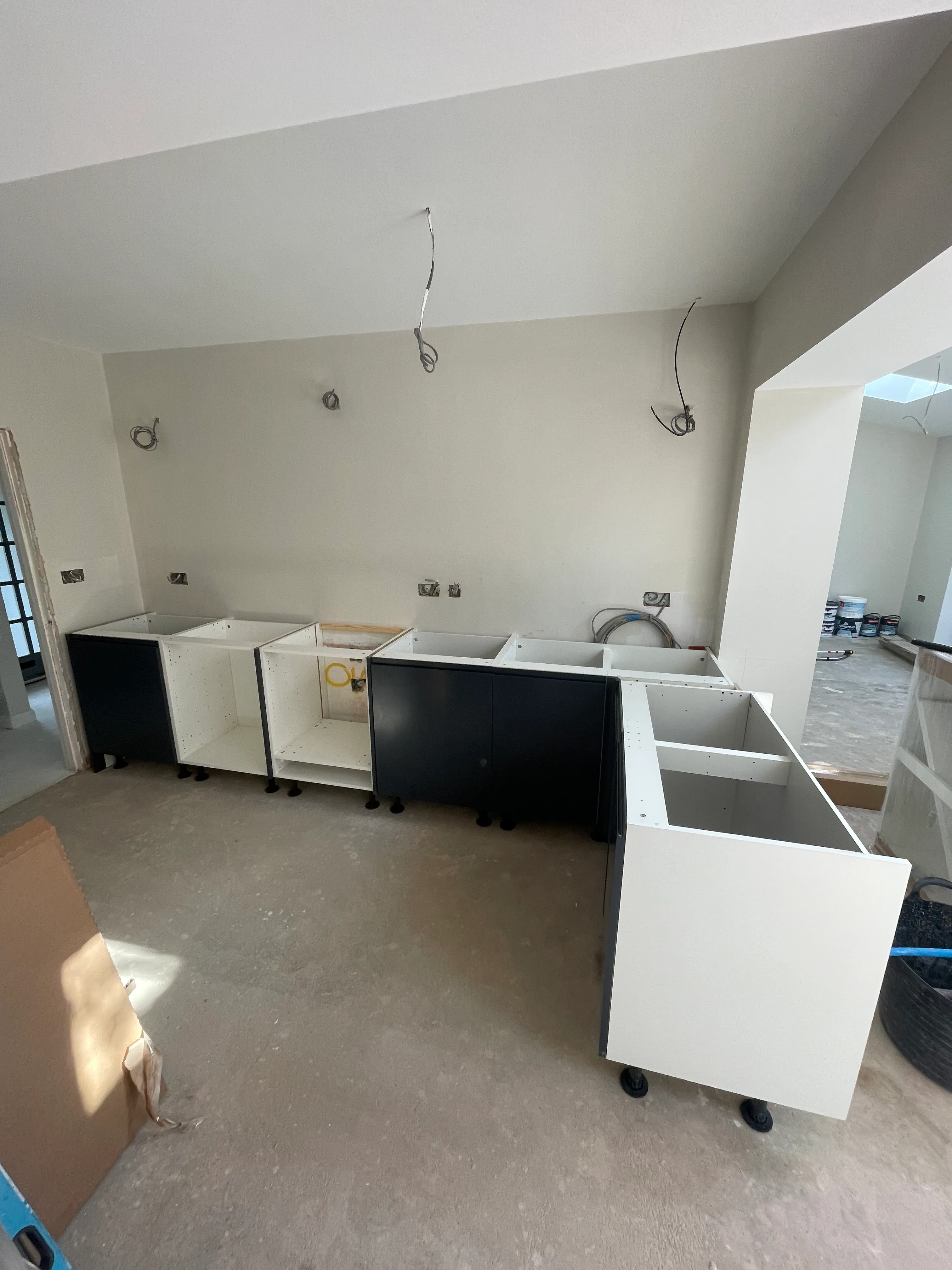 Built-in unit carcasses being installed during the kitchen build.
