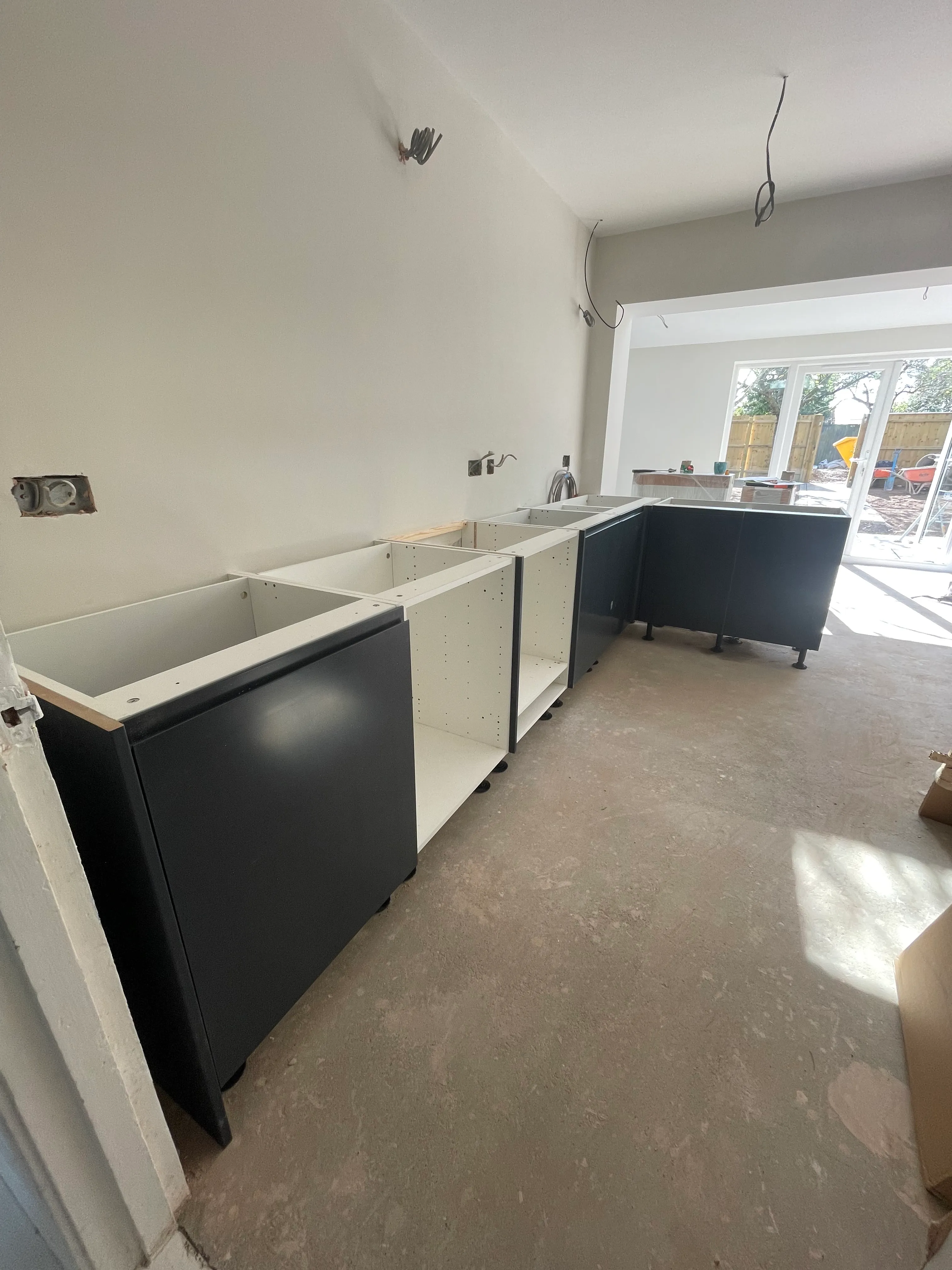 Bespoke kitchen drawer fronts laid out before installation.