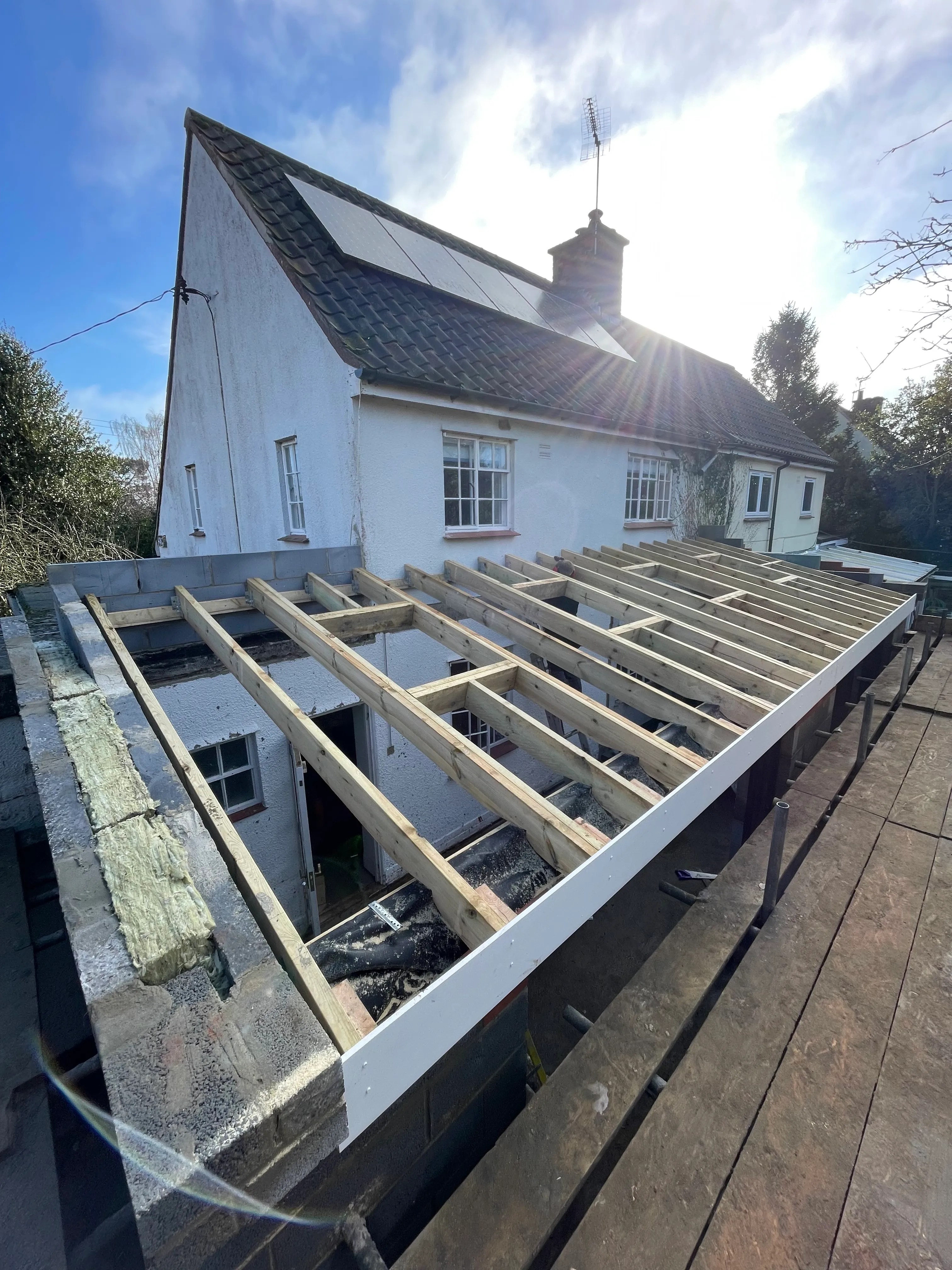 Timber-framed rear extension under construction.