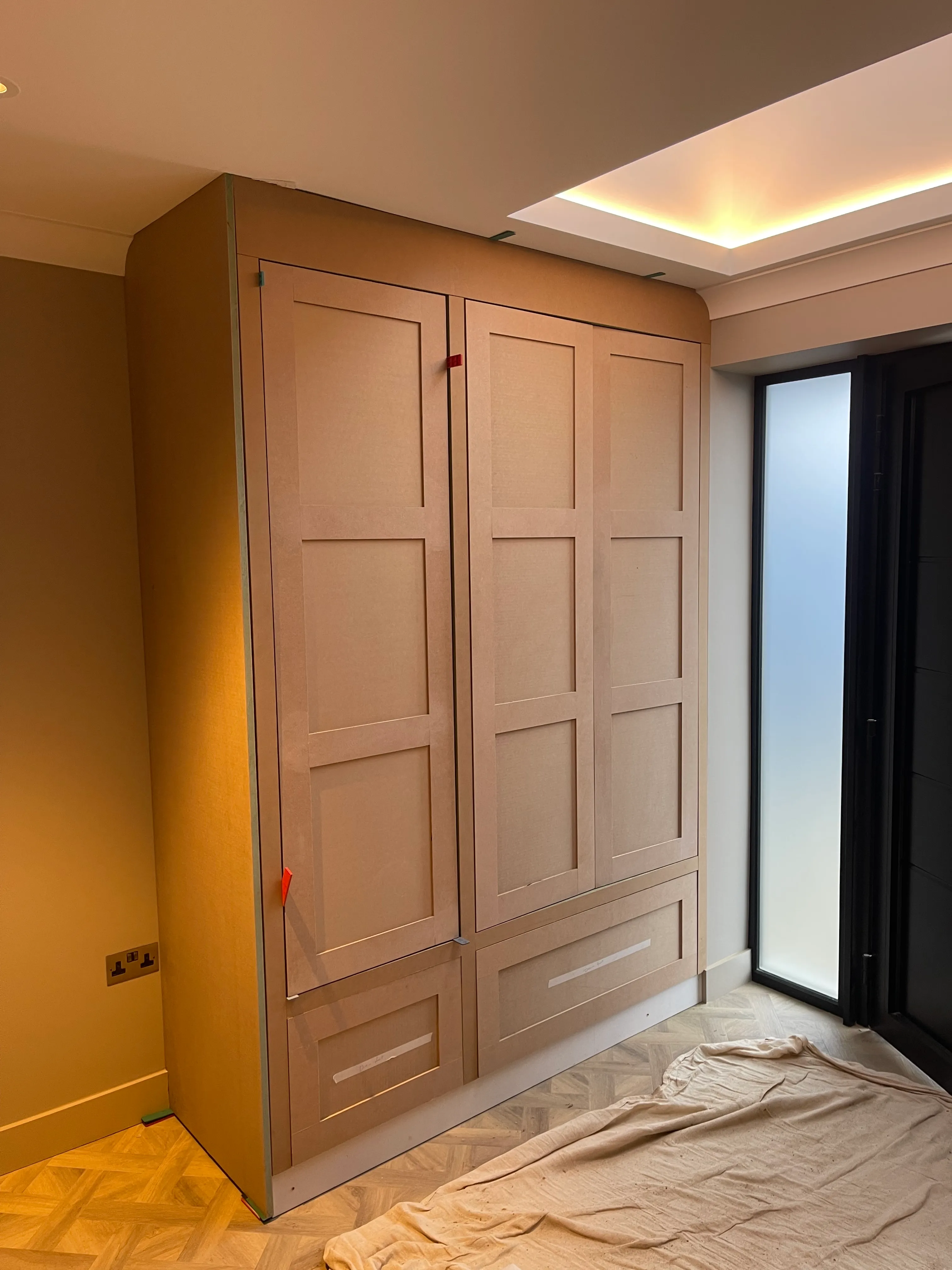 Hallway storage cabinet in primer ahead of finishing.
